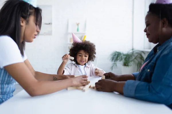 Positive African American Girl Party Cap Playing Wood Blocks Game — Stock Photo, Image