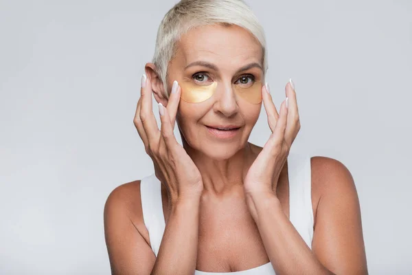 Pleased Senior Woman Applying Collagen Eye Patches Isolated Grey — Stock Photo, Image