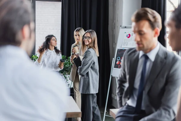 Happy Woman Holding Coffee Colleagues Blurred Multiethnic Businessmen — Fotografia de Stock