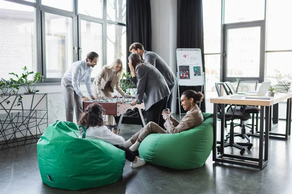 Young Business People Playing Table Football Interracial Colleagues Sitting Bag — Stock Photo, Image