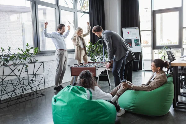 Excited Business People Showing Win Gesture While Playing Table Football — Stockfoto