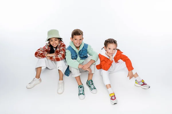 Full Length Cheerful Kids Smiling While Sitting White - Stock-foto