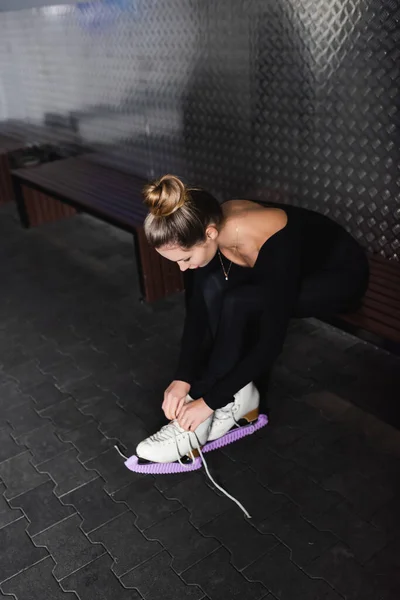 Young Woman Tying Figure Skating Shoes While Sitting Bench — Foto Stock