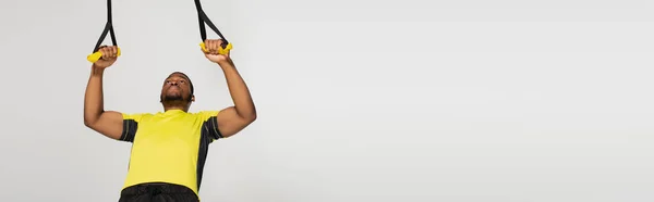 Strong African American Sportsman Exercising Resistance Bands Isolated Grey Banner — Stock Photo, Image