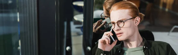 Young Man Eyeglasses Talking Cellphone Hotel Banner — стоковое фото