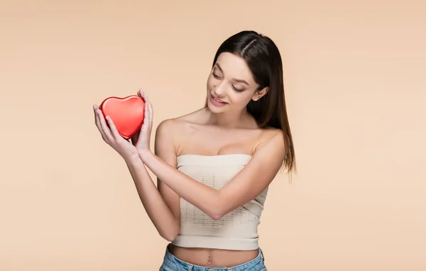 Mutlu Genç Bir Kadın Bej Üzerinde Izole Edilmiş Kırmızı Kalp — Stok fotoğraf