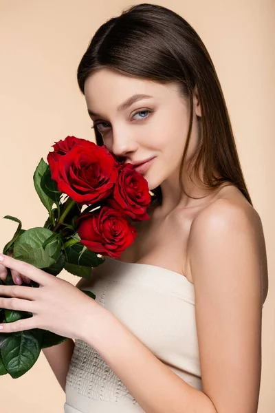 Pleased Young Woman Bare Shoulders Smelling Red Roses Isolated Beige — Foto Stock