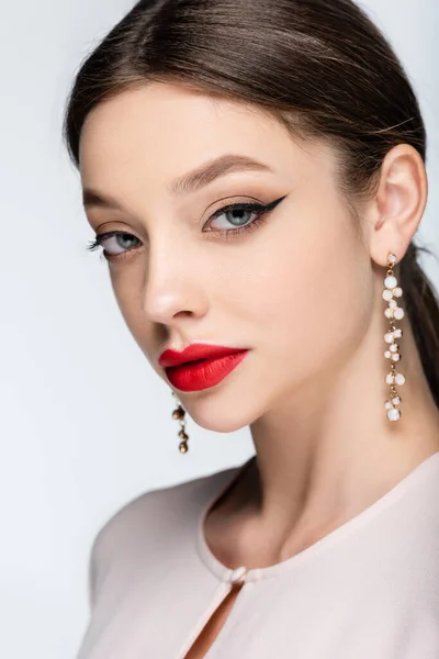 Young Woman Earrings Red Lips Looking Camera Isolated Grey — стоковое фото