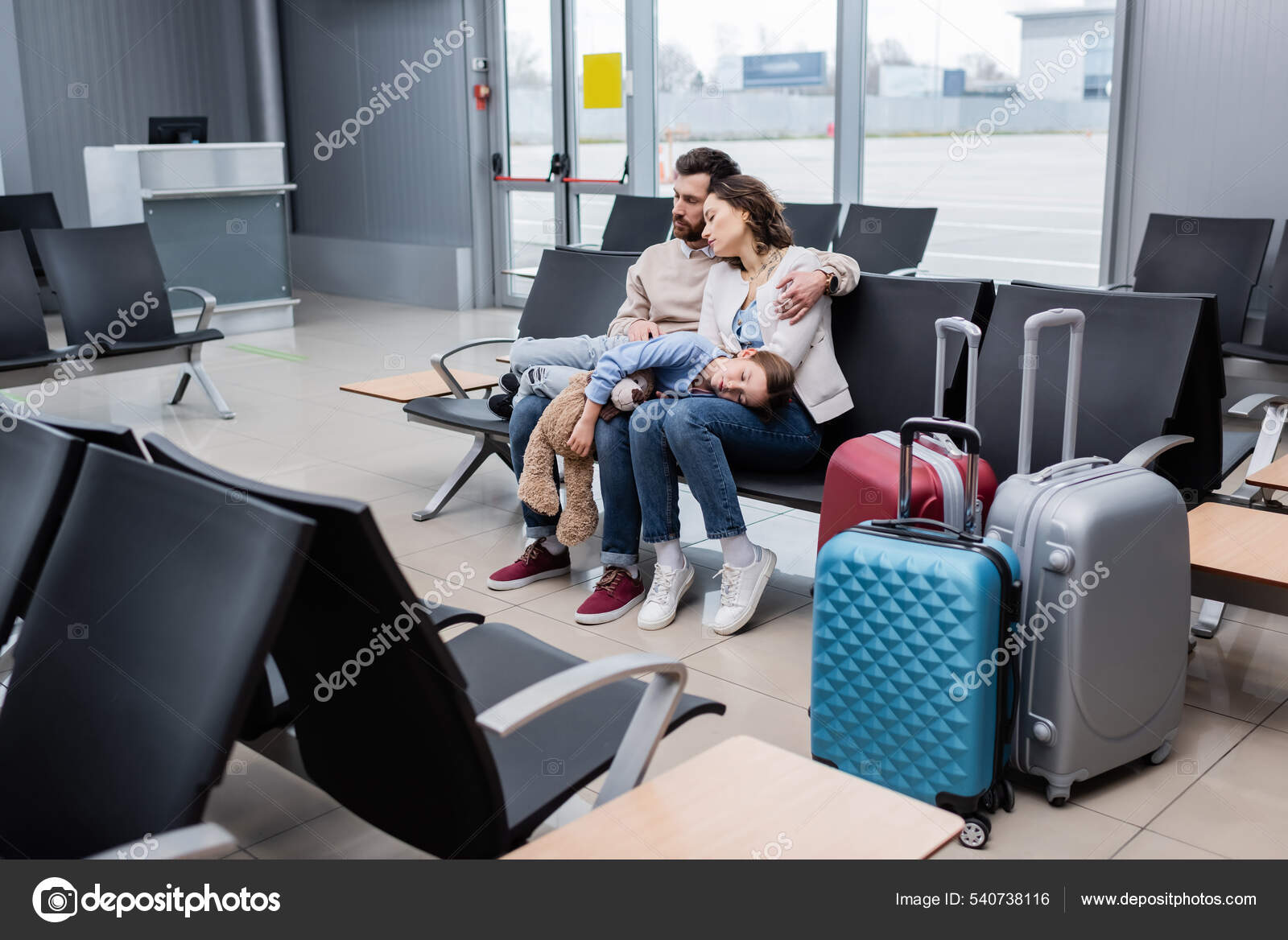 Girl Sleeping Knees Tired Parents Airport Lounge Stock Photo by