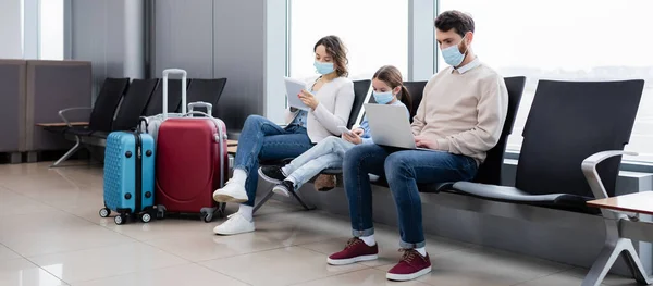 Family Medical Masks Using Gadgets Airport Banner — Stock Fotó