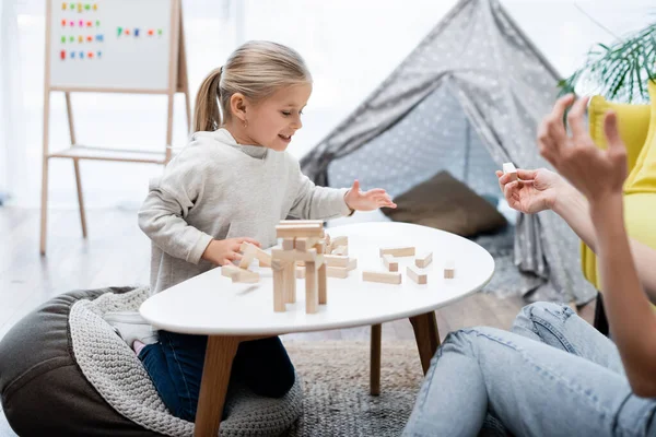 Smiling Kid Playing Wood Blocks Game Mom Home — Stockfoto