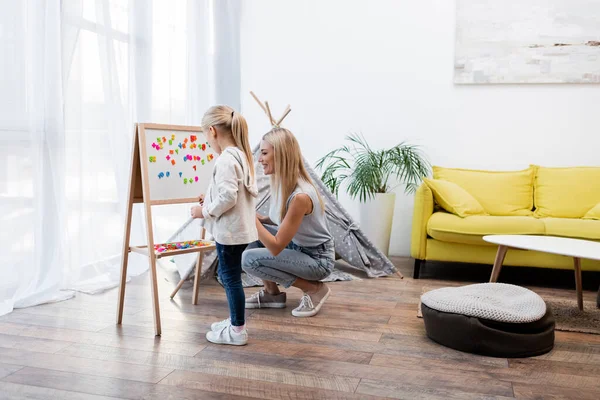 Woman Looking Magnetic Easel Kid Teepee Home — Photo