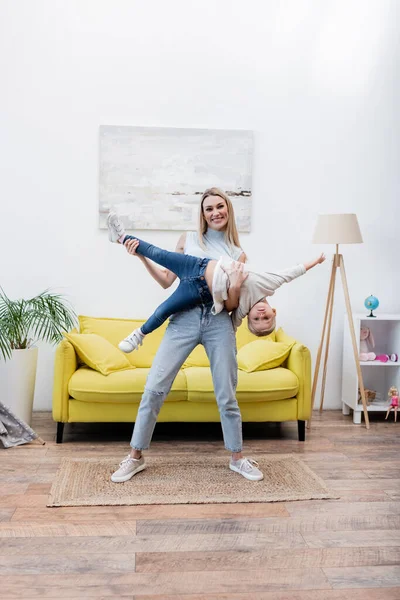 Smiling Mom Lifting Daughter Looking Camera Home — 스톡 사진