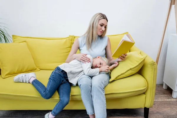 Mother Reading Book Kid Couch Home — стоковое фото