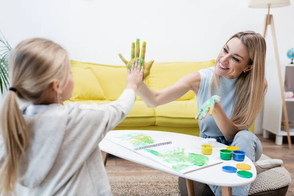 Smiling Woman Kid Paint Hands Giving High Five Home — Stockfoto