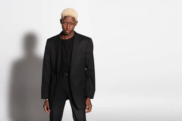 Framsidan Afrikansk Amerikansk Man Svart Kostym Tittar Kameran Grå Med — Stockfoto