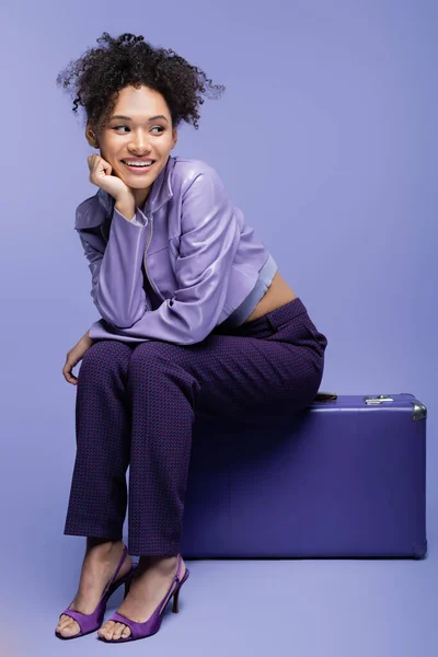 Full Length Happy African American Woman Sitting Suitcase Purple — Stock Photo, Image