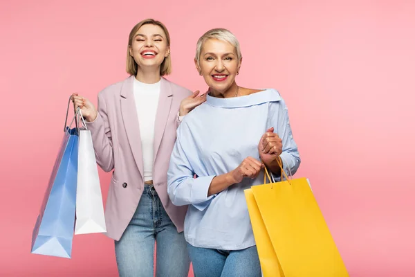Positive Young Woman Mature Mother Holding Shopping Bags Isolated Pink — Stock Photo, Image