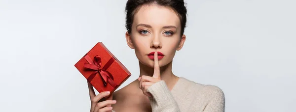 Brunette Woman Showing Secret Gesture Holding Red Gift Box Isolated — Stock Photo, Image