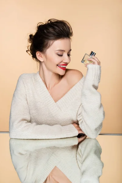 Smiling Model Cozy Sweater Holding Perfume Bottle Mirror Isolated Beige — Stock Photo, Image