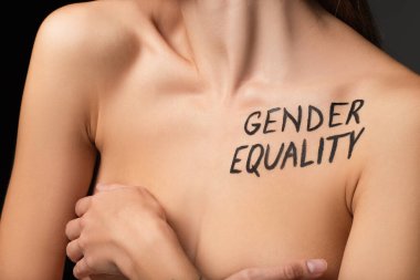partial view of nude woman with gender equality lettering on body  clipart