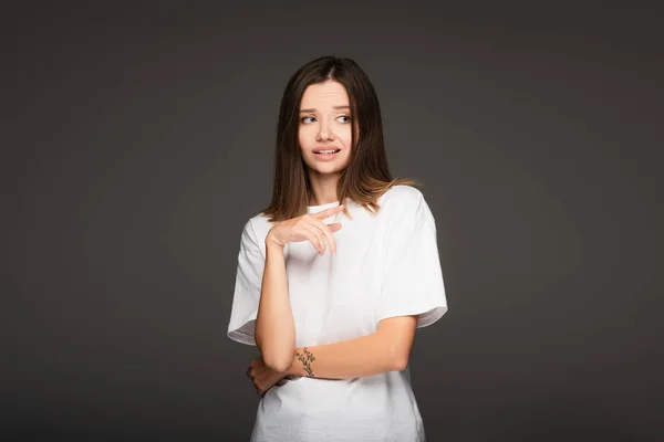 Frightened Woman White Shirt Pointing Finger Isolated Dark Grey — Stock Photo, Image