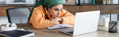 arabian woman focused on online webinar while learning at home, banner clipart
