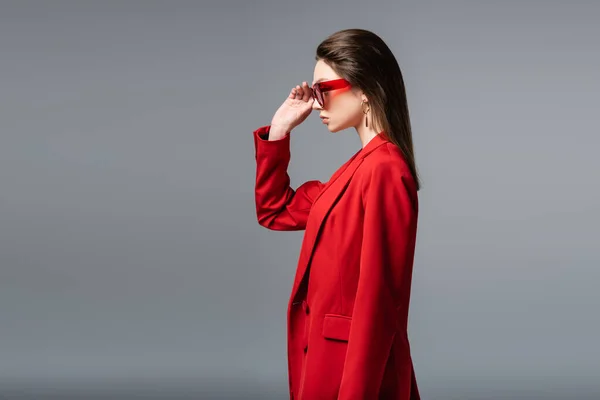 Side View Young Woman Trendy Red Suit Adjusting Sunglasses Isolated — Stock Photo, Image