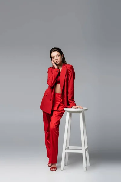 Full Length Young Woman Trendy Red Suit Posing White Chair — Stock Photo, Image