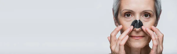 Close Mature Woman Grey Hair Applying Patch Nose Isolated Grey — Stock Photo, Image