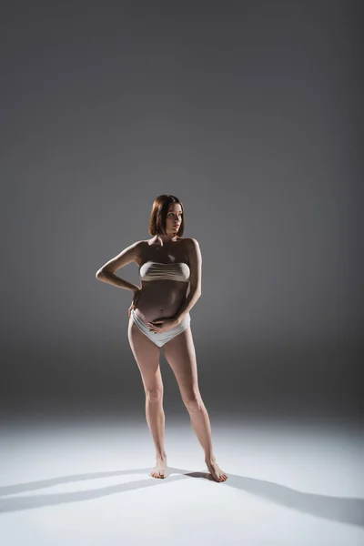 Gravid Kvinna Underkläder Vidrör Magen Grå Bakgrund — Stockfoto