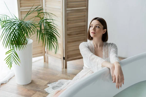 Young Woman Robe Looking Away Bathtub Plant Bathroom — Stock Photo, Image
