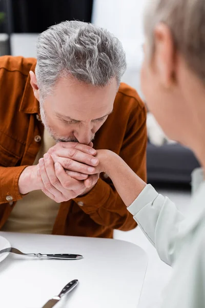 Mature Man Kissing Hand Blurred Wife Kitchen — Stock Photo, Image