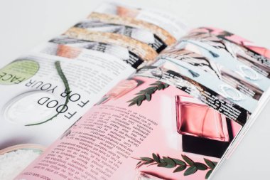 close up view of beauty magazines isolated on grey clipart
