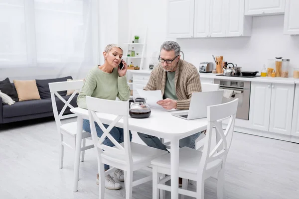 Elderly Woman Talking Smartphone While Husband Holding Paper Coffee Laptop — Stock Photo, Image