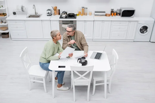 High Angle View Pensioners Holding Papers Talking Coffee Gadgets Kitchen — Stock Photo, Image