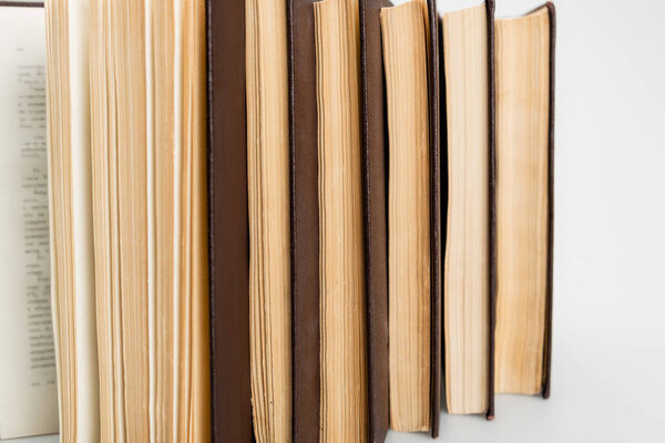 close up view of several paper books on grey background