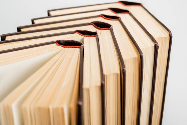 close up view of paper books collection isolated on grey