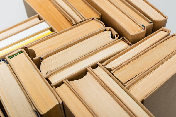 top view of paper books collection isolated on grey