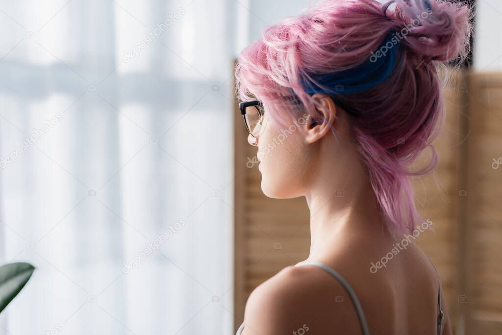 young woman with dyed hair looking away