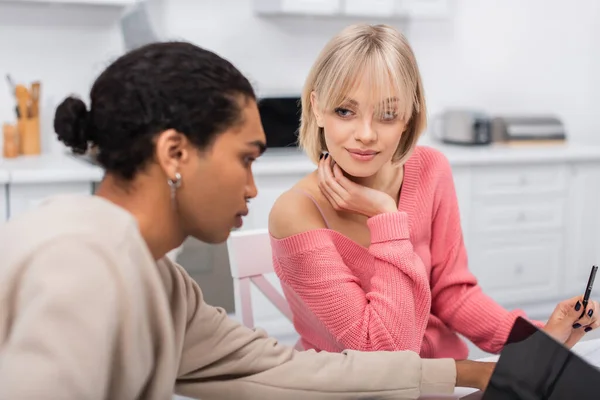 Blonde Woman Looking African American Boyfriend Using Laptop — Foto de Stock