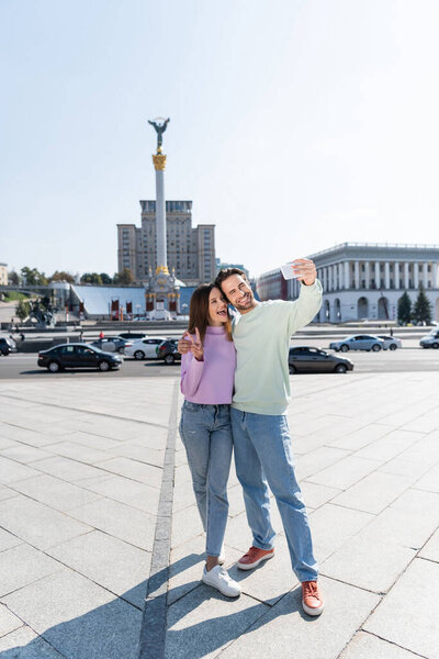 KYIV, UKRAINE - SEPTEMBER 1, 2021: Smiling couple taking selfie on Independence Square 