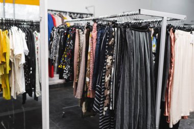 Pants on hangers in blurred vintage shop 
