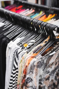 High angle view of blouses on hangers in retro shop 