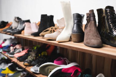 Shoes on shelves in second hand 