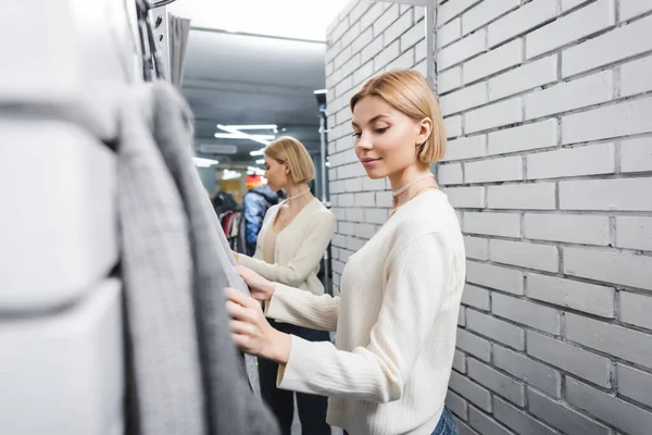 Young Customer Looking Blurred Clothes Dressing Room Second Hand — стоковое фото