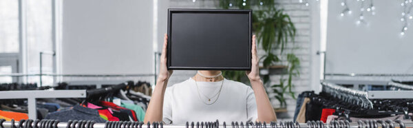 Saleswoman holding board with copy space in second hand, banner 