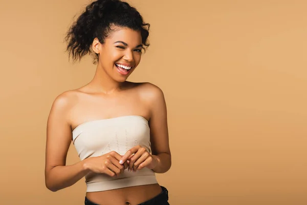Cheerful African American Woman Bare Shoulders Winking Camera Isolated Beige — Stock Photo, Image