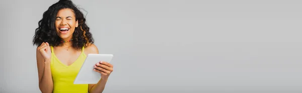 Wesoła Afroamerykanka Żółtej Bluzce Trzymająca Cyfrową Tabletkę Szarym Szarym Transparencie — Zdjęcie stockowe