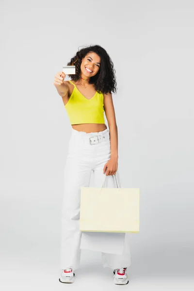 Happy African American Woman Holding Paper Bags Credit Card Grey — Stock Photo, Image